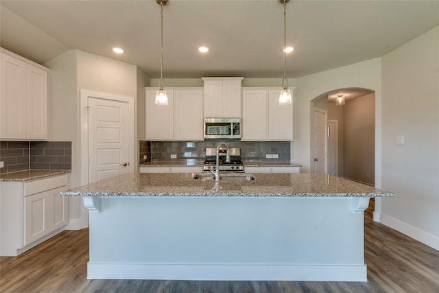 kitchen with white cabinetry, a kitchen island with sink, and stainless steel appliances