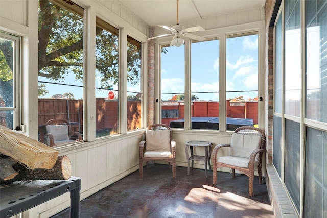 sunroom featuring ceiling fan