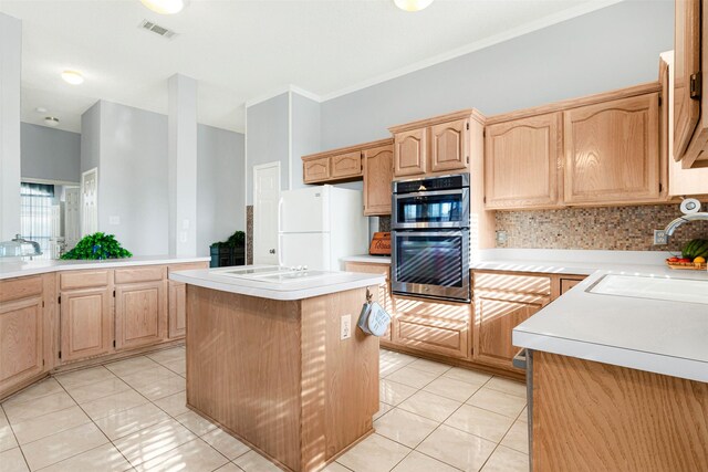 kitchen featuring a center island, white appliances, sink, tasteful backsplash, and light tile patterned flooring