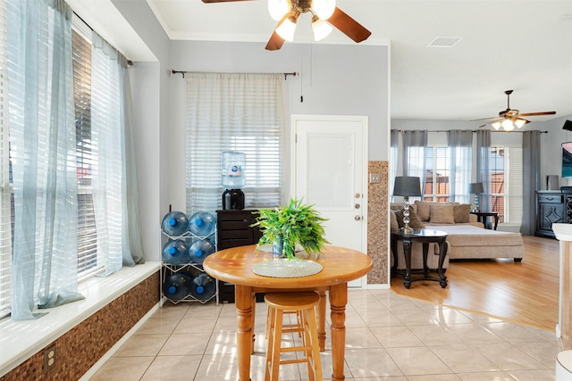 tiled dining area featuring ornamental molding