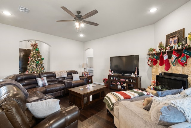 living room with dark wood-type flooring and ceiling fan