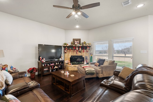 living room with ceiling fan, a fireplace, and wood-type flooring