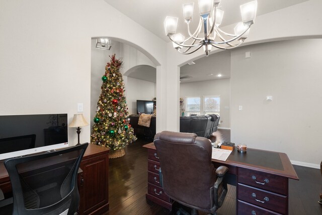 home office featuring dark hardwood / wood-style flooring and an inviting chandelier