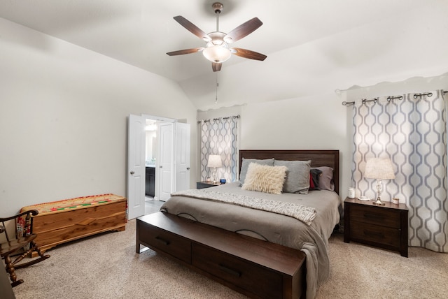 carpeted bedroom with lofted ceiling, ensuite bath, and ceiling fan