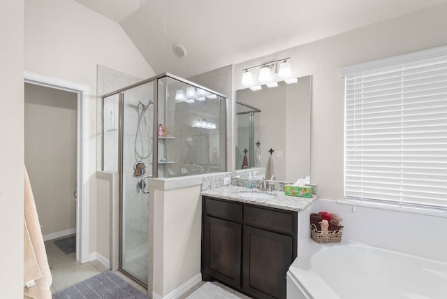 bathroom featuring vanity, vaulted ceiling, and independent shower and bath