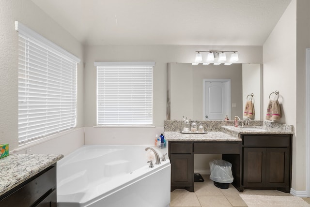 bathroom with vanity, tile patterned flooring, and a tub