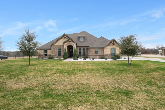 french country style house with a front yard