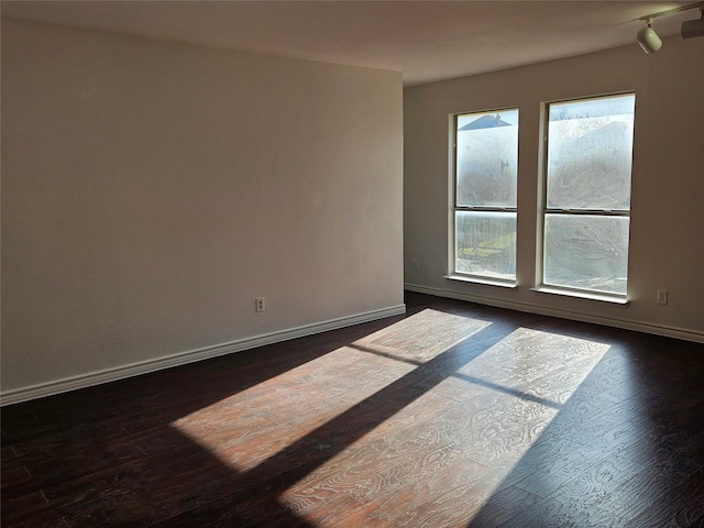 empty room with dark wood-type flooring