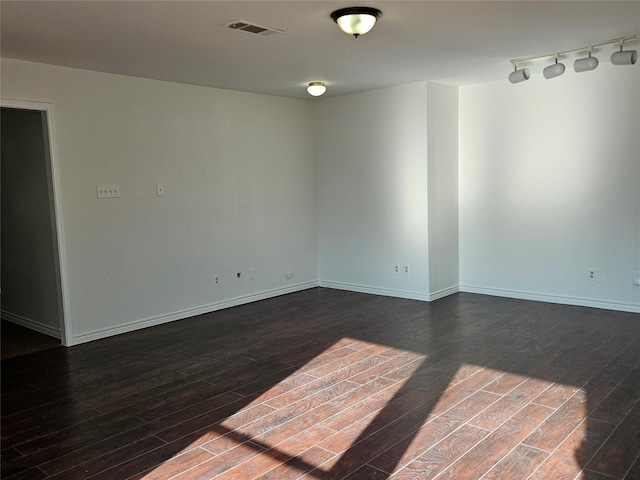 unfurnished room with dark wood-type flooring