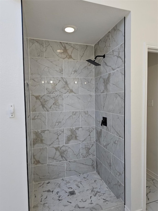 bathroom with tiled shower