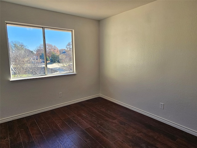 unfurnished room featuring dark hardwood / wood-style flooring