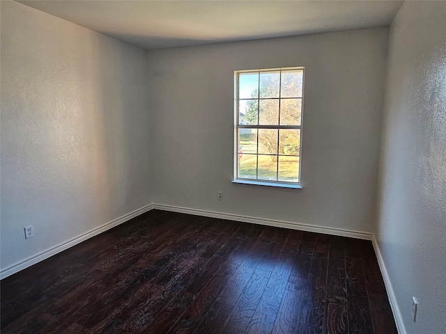 spare room with dark hardwood / wood-style floors