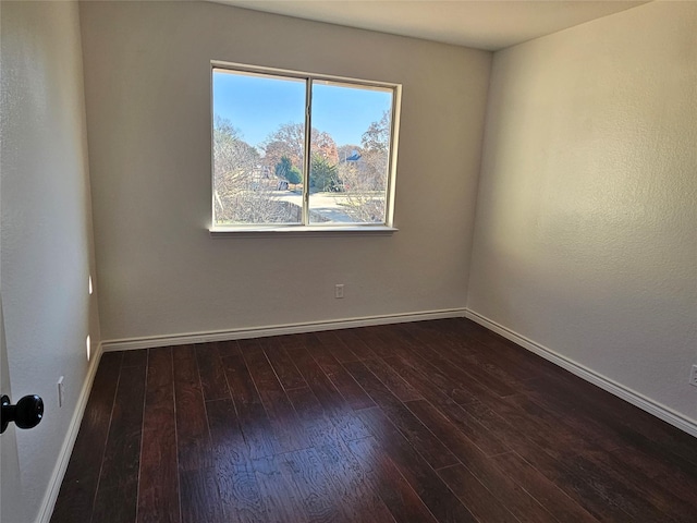 spare room with dark wood-type flooring