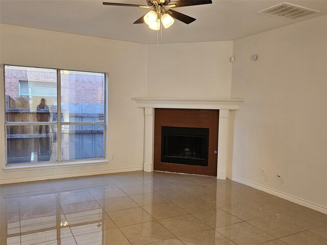 unfurnished living room with tile patterned floors and ceiling fan