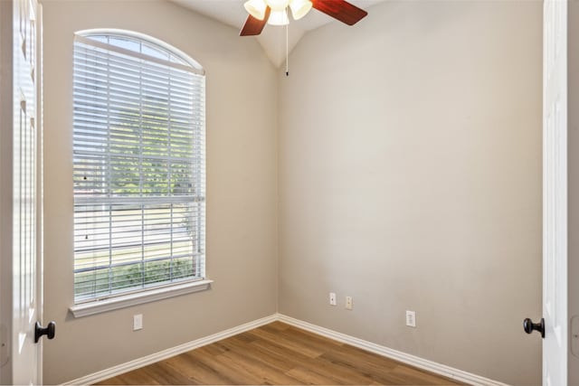 spare room featuring ceiling fan, wood-type flooring, and vaulted ceiling