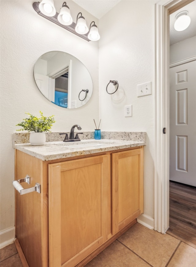 bathroom with tile patterned floors and vanity