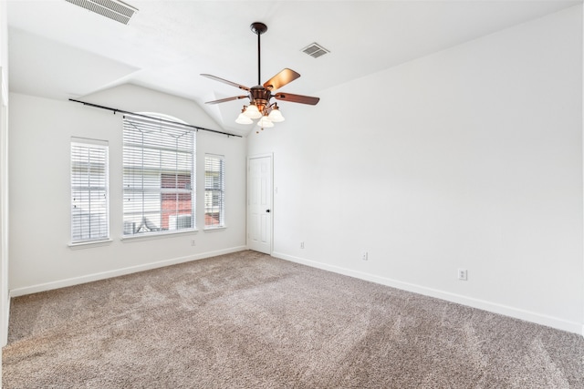 empty room with ceiling fan, lofted ceiling, and carpet floors