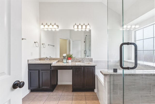 bathroom with tile patterned floors, a shower with door, vanity, and lofted ceiling