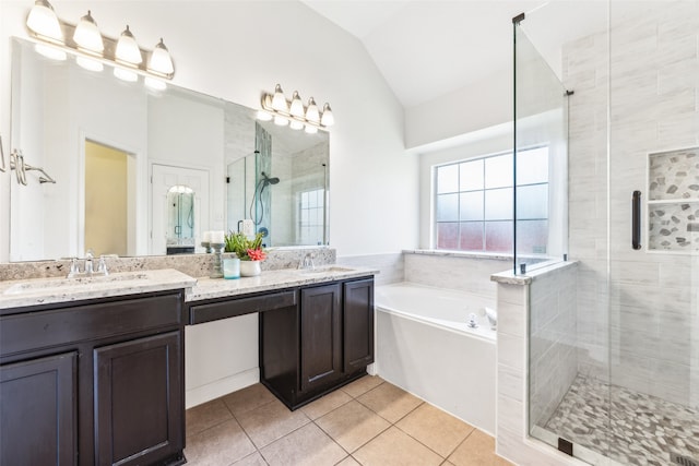 bathroom featuring tile patterned flooring, vanity, separate shower and tub, and lofted ceiling