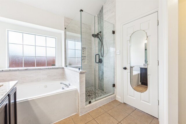 bathroom with tile patterned floors, vanity, and independent shower and bath