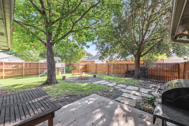 view of yard featuring a patio and an outdoor fire pit