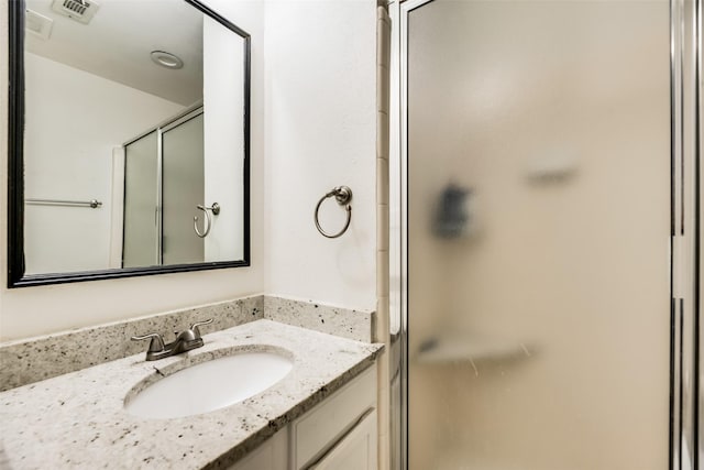 bathroom with vanity and an enclosed shower