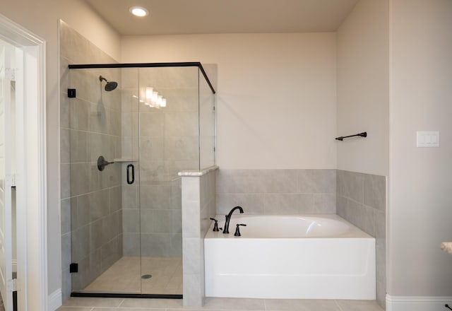 bathroom featuring tile patterned floors and shower with separate bathtub