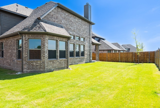 rear view of house with a lawn