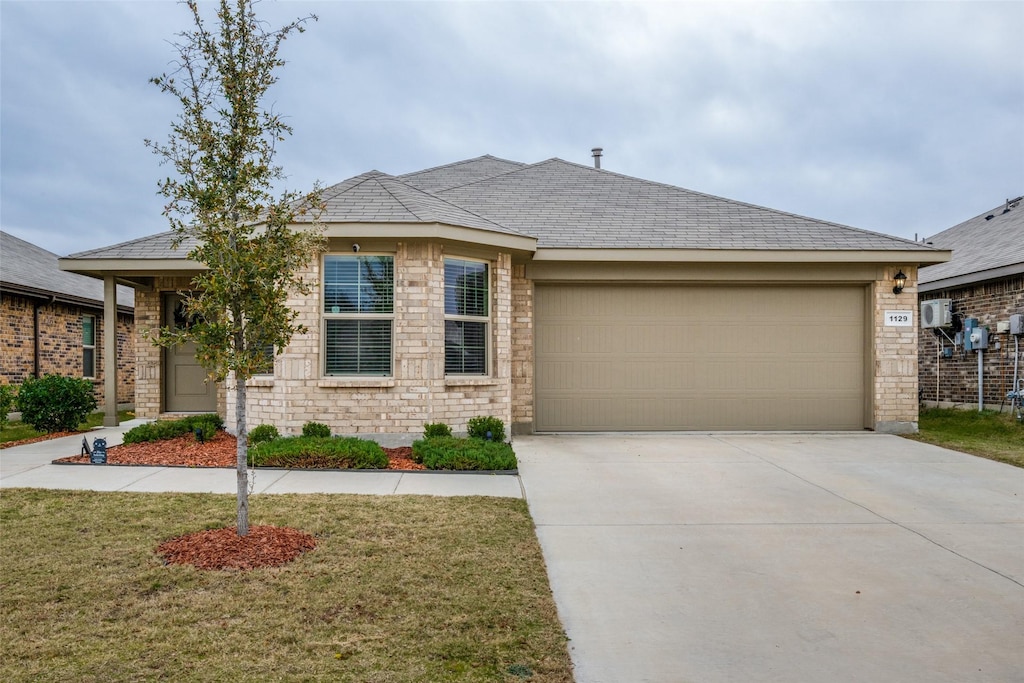 view of front of home featuring a garage and a front lawn