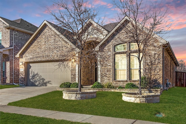 front facade featuring a yard and a garage