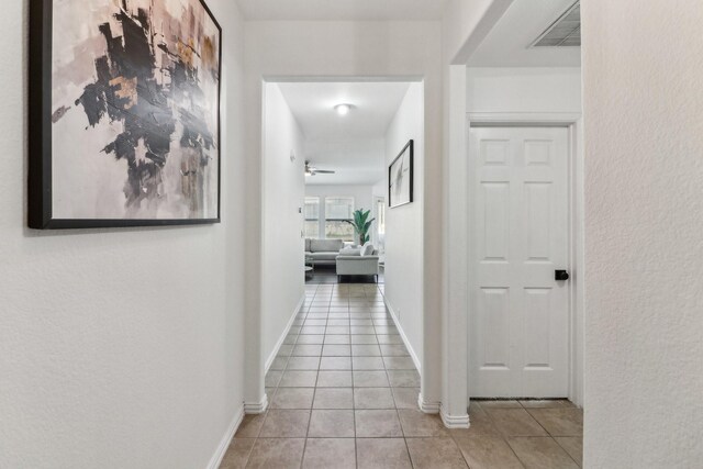 hallway featuring light tile patterned floors