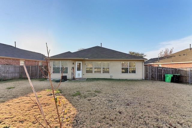 rear view of property with a yard