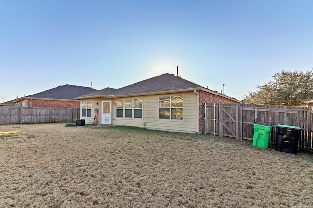 back of house with a lawn