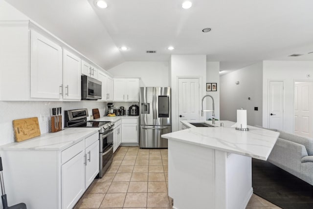 kitchen with white cabinets, sink, an island with sink, and stainless steel appliances