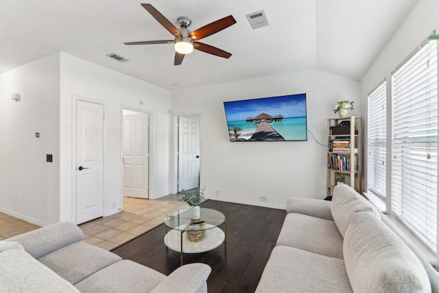 living room featuring light hardwood / wood-style flooring, vaulted ceiling, and ceiling fan