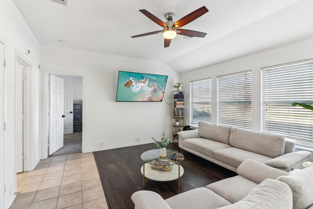 living room with ceiling fan, lofted ceiling, and light tile patterned floors