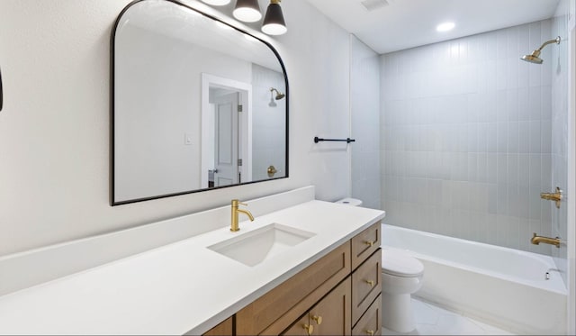 full bathroom with vanity, toilet, and tiled shower / bath combo