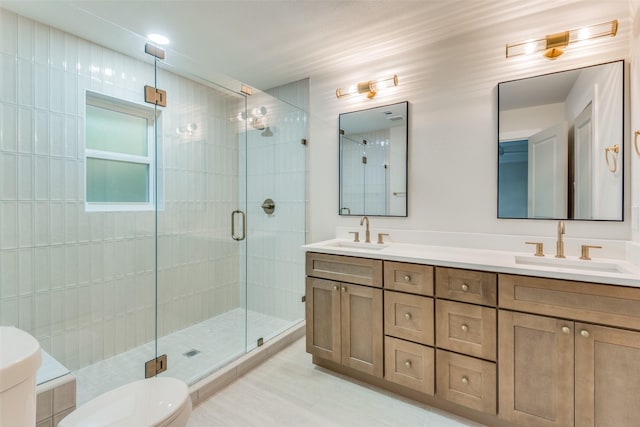 bathroom with an enclosed shower, vanity, and toilet