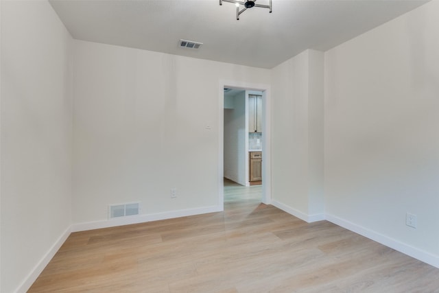 spare room featuring light wood-type flooring