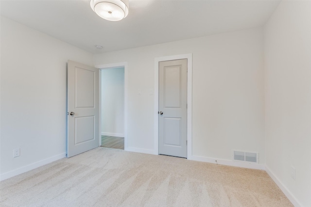 spare room with light colored carpet