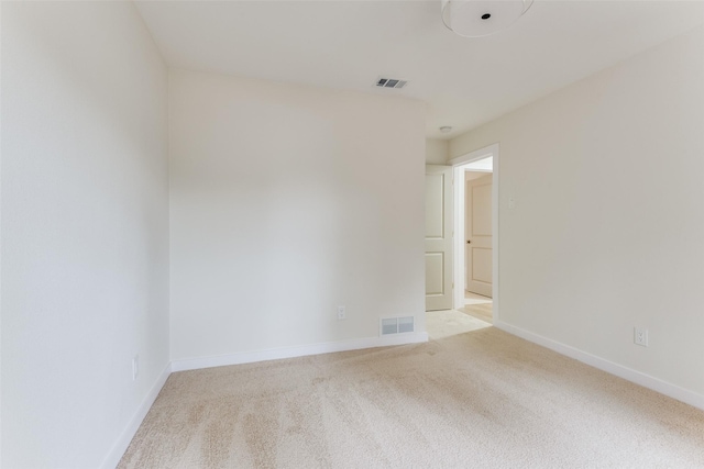 empty room featuring light carpet