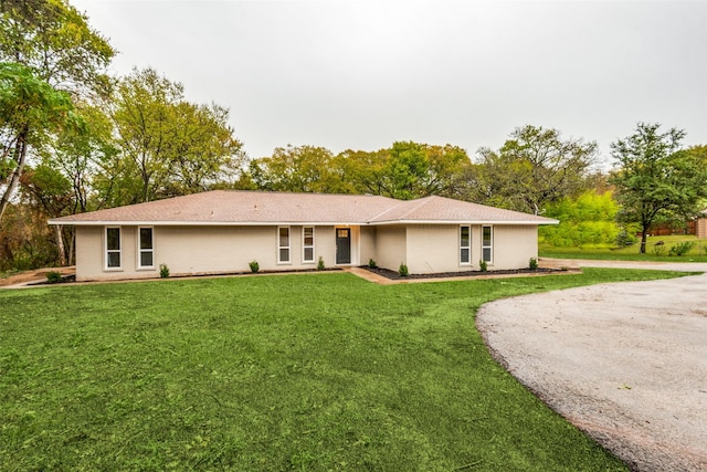 ranch-style home with a front yard