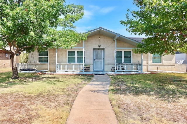 view of front facade with a front lawn and covered porch