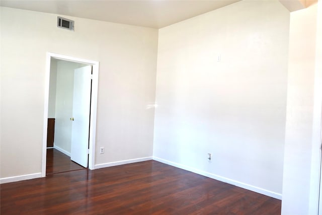 unfurnished room with dark hardwood / wood-style flooring