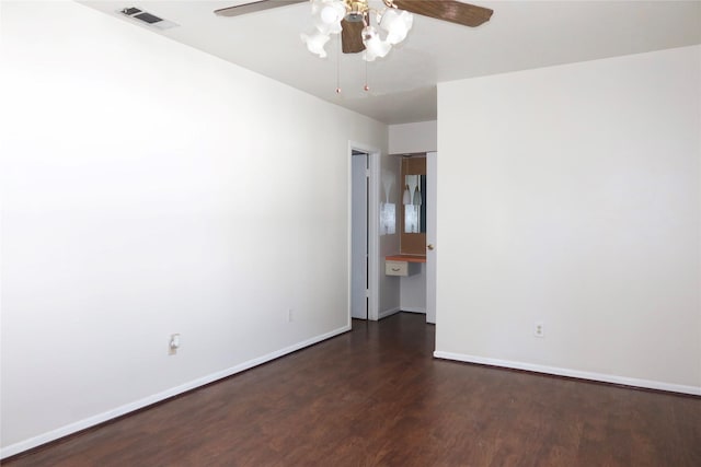 spare room featuring ceiling fan and dark wood-type flooring