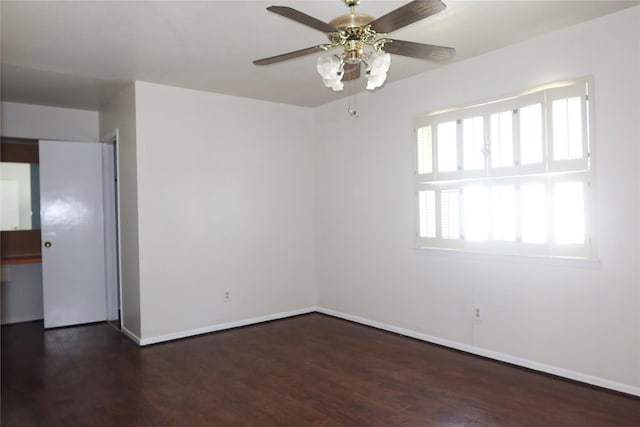 empty room featuring dark wood-type flooring and ceiling fan