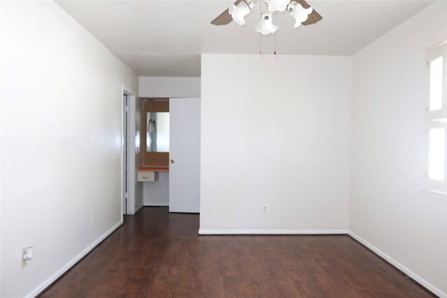 empty room featuring ceiling fan and dark hardwood / wood-style flooring