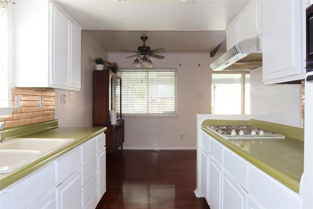 kitchen with white gas stovetop, exhaust hood, sink, ceiling fan, and white cabinetry