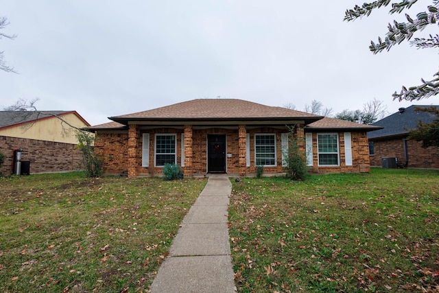 view of front of house featuring a front yard and central air condition unit