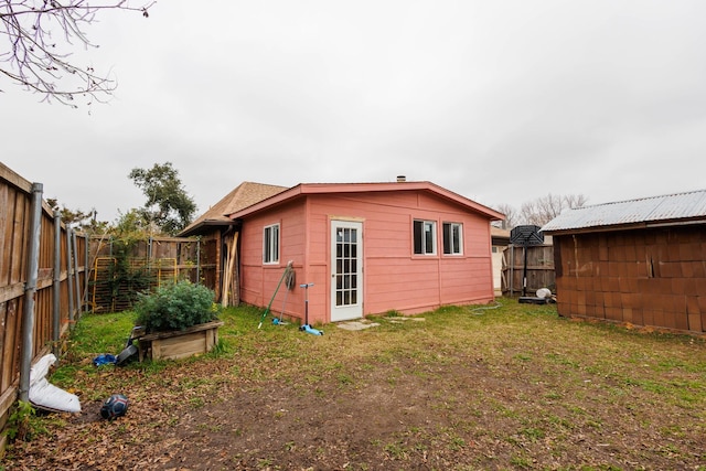 rear view of property with a yard